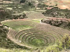 Concentric Inca terraces cut in rings into a green bowl in the hillside