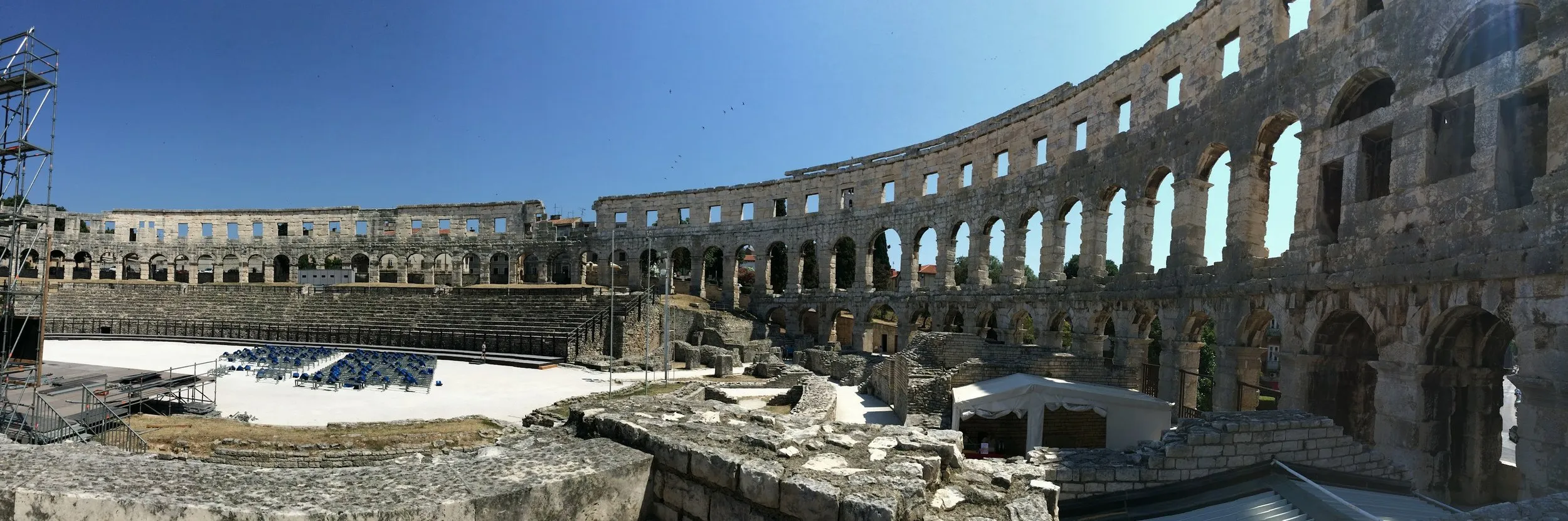 The tiered stone arches of the Roman amphitheatre curving around the open arena floor